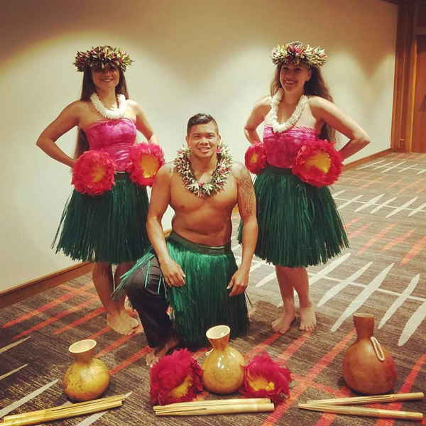 Genuine Hawaiian entertainment performers posing in hula costumes before a performance | Altus Entertainment