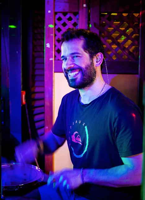 Drummer for pop rock band in France grinning for picture and passionately playing drums at private event | Altus Entertainment
