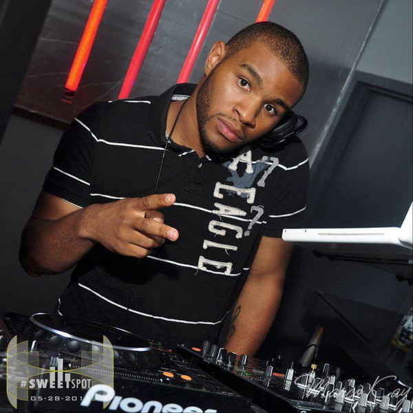 Male DJ Washington DC looking to camera for picture while holding headphone up to ear | Altus Entertainment