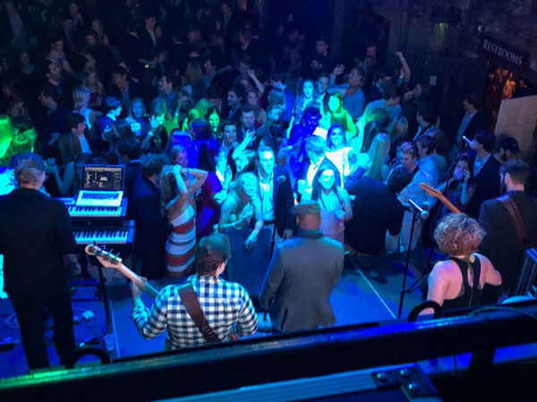 Texas variety cover band performing onstage as audience members dance and laugh in excitement at event | Altus Entertainment