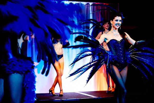 French cabaret dancers smiling to audience and walking across stage during French cabaret show | Altus Entertainment