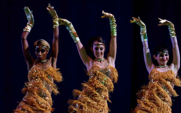 Female French cabaret dancers costumed in yellow fringed dresses and satin gloves dancing happily | Altus Entertainment