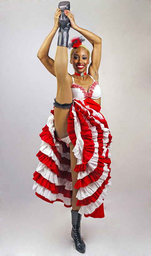 French cabaret dancer lifting leg above head and costumed in white and red dress to promote French cabaret show | Altus Entertainment