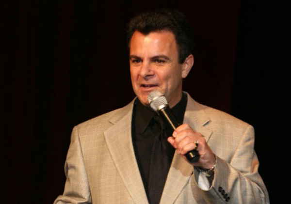 Lead male cover singer holding microphone close to mouth while singing to audience | Altus Entertainment