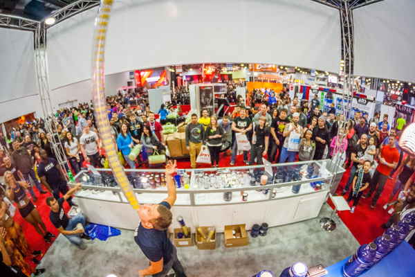 Wide angled picture of Las Vegas flair bartender balancing large stack of glasses on chin | Altus Entertainment