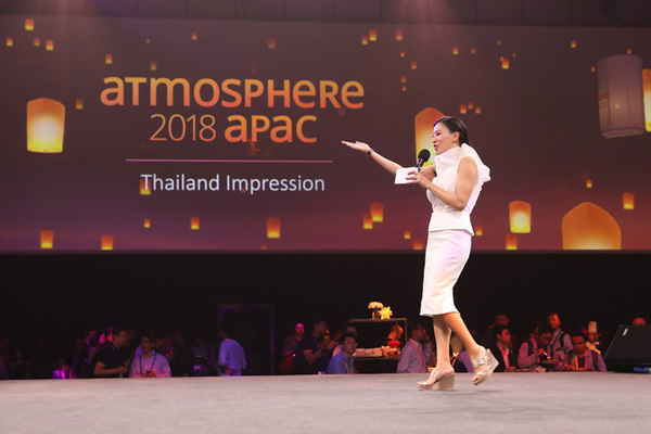 Female event emcee in Thailand walking across stage during Atmosphere 2018 APAC conference | Altus Entertainment