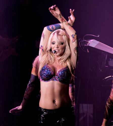Britney Spears impersonator for events dancing with arms over top her head as backup dancers dance around her | Altus Entertainment