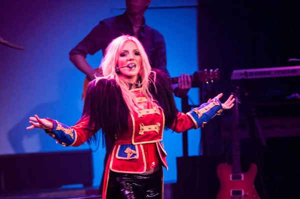 Female Britney Spears impersonator for events walking with arms stretched while singing onstage | Altus Entertainment